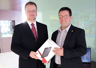 Angus Cameron of CDL Scotland presents tablet to Graeme Fox