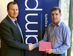 AMP regional sales manager Lloyd Grimes (left) presents a prize of a luxury weekend break for two to Simon Jenson, contracts manager at Quantech Environmental